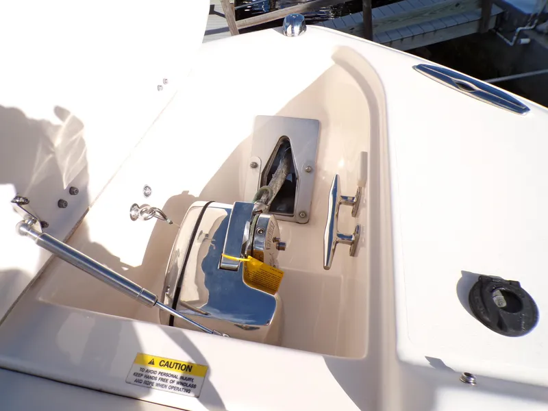 Slide: The Image of 2016 Grady-White Freedom 275 boat anchor compartment with winch and cleat. - 20