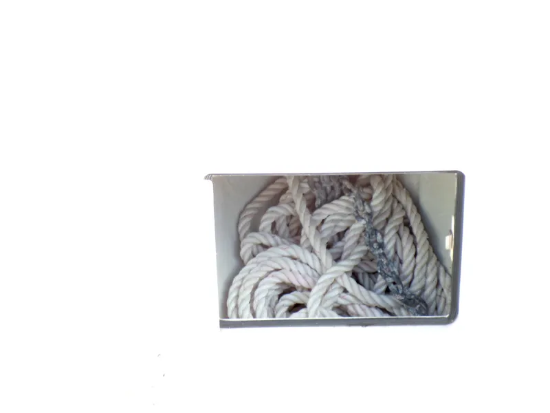 Slide: The Image of Storage compartment with coiled rope on a 2016 Grady-White Freedom 275 boat. - 25