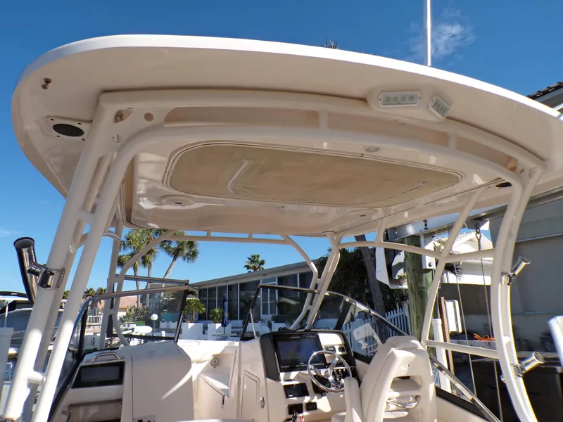 Slide: The Image of 2016 Grady-White Freedom 275 boat interior with helm and seating under hardtop. - 29