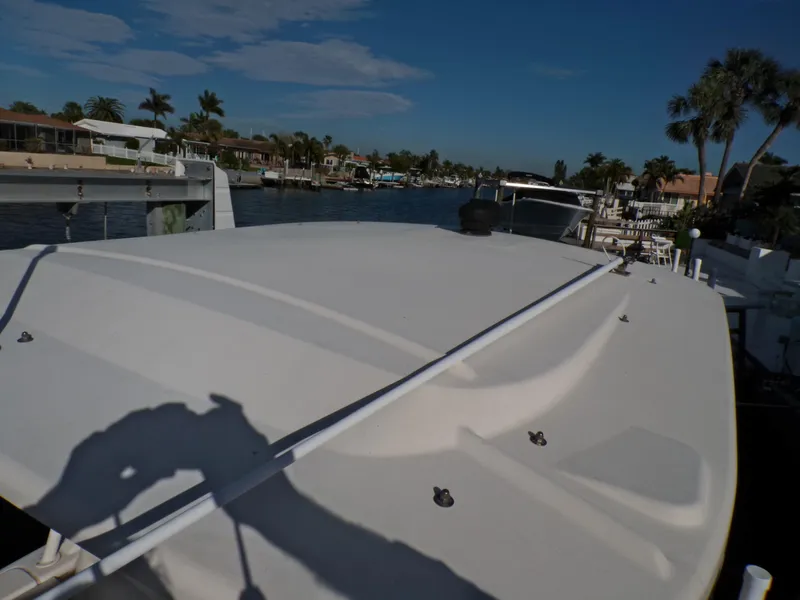 Slide: The Image of 2016 Grady-White Freedom 275 boat docked in a scenic waterfront area. - 30