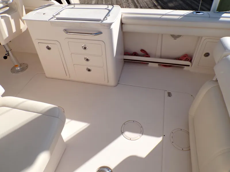 Slide: The Image of 2016 Grady-White Freedom 275 boat interior with storage compartments and seating. - 31