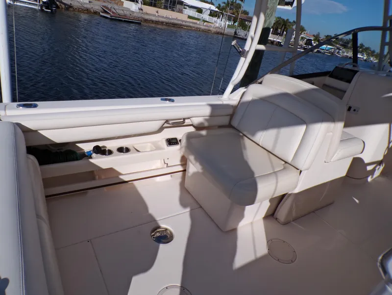 Slide: The Image of 2016 Grady-White Freedom 275 boat interior with seating, dockside view. - 32