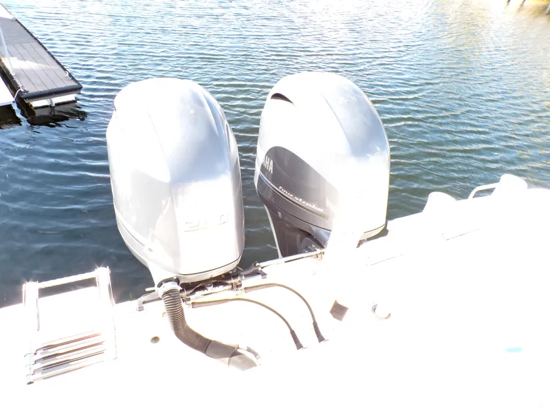 Slide: The Image of Twin outboard motors on a 2016 Grady-White Freedom 275 boat, docked on water. - 33