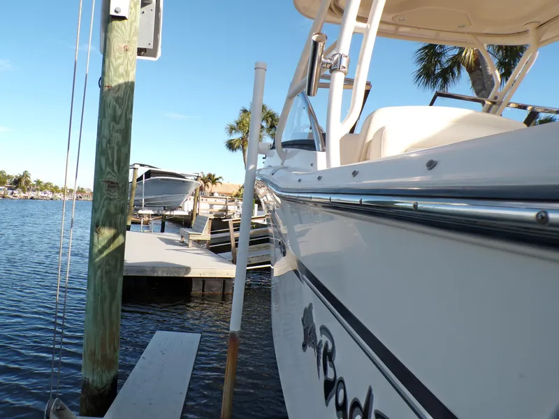 Slide: The Image of 2016 Grady-White Freedom 275 boat docked by a scenic waterfront. - 42