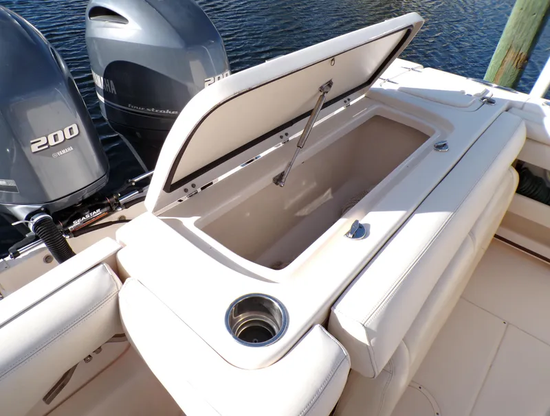 Slide: The Image of 2016 Grady-White Freedom 275 boat with open storage compartment and twin Yamaha 200 engines. - 44