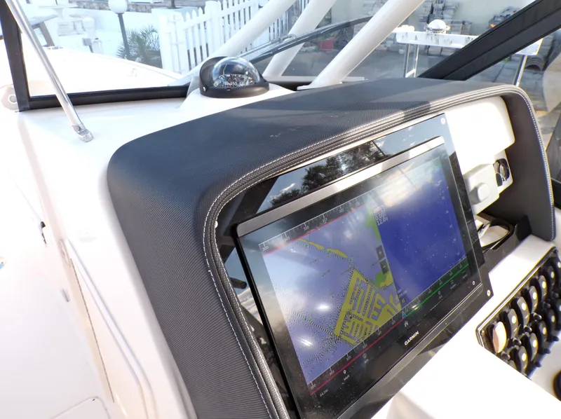 Slide: The Image of 2016 Grady-White Freedom 275 dashboard with navigation display and controls. - 47