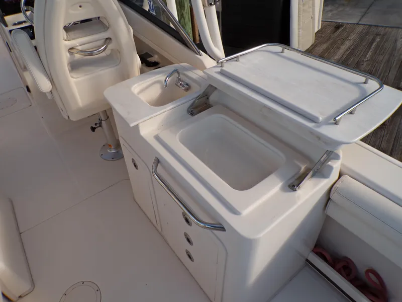 Slide: The Image of 2016 Grady-White Freedom 275 boat interior with sink and storage area. - 48