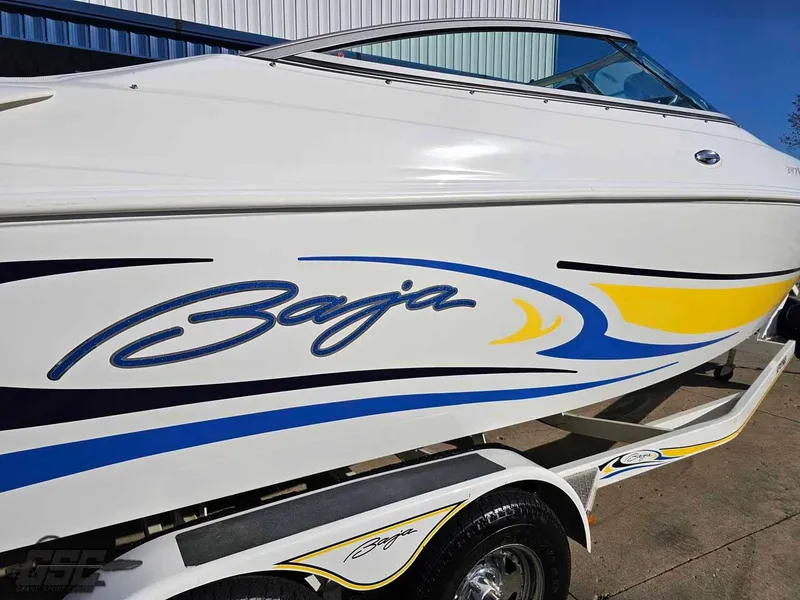 Slide: The Image of 2008 Baja 247 Islander boat with vibrant blue and yellow graphics on a trailer. - 10