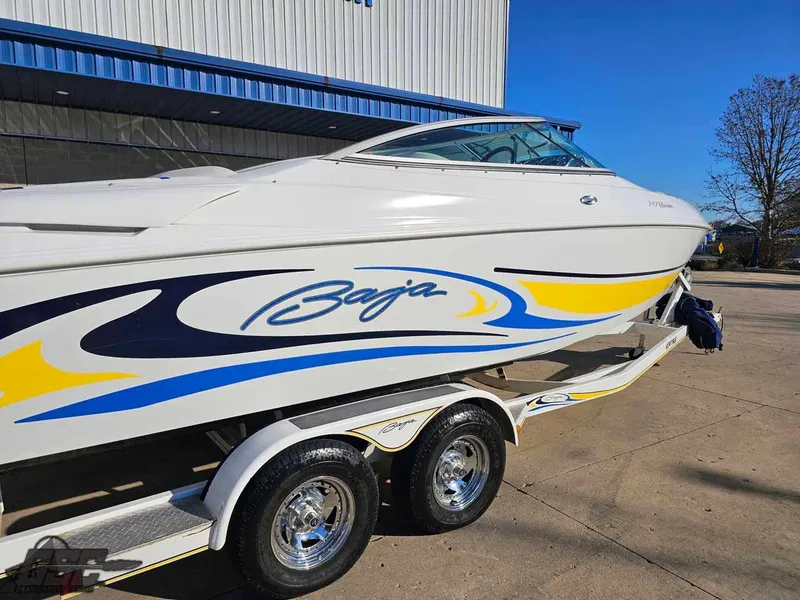 Slide: The Image of 2008 Baja 247 Islander boat on trailer, featuring vibrant blue and yellow graphics. - 11