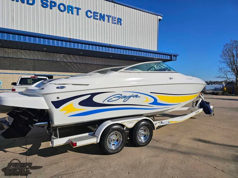 Slide: The Image of 2008 Baja 247 Islander boat on trailer outside a sports center. - 12