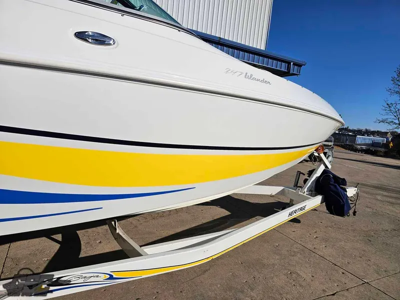Slide: The Image of 2008 Baja 247 Islander boat with yellow and blue accents on a trailer. - 13