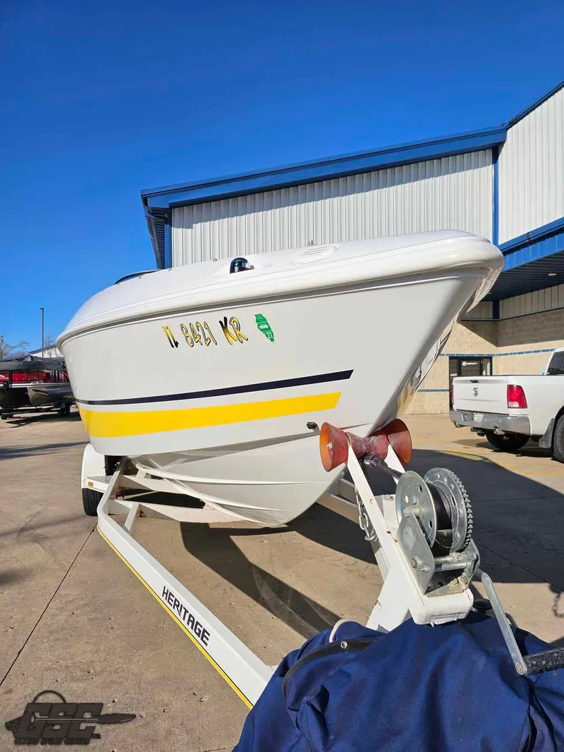 Slide: The Image of 2008 Baja 247 Islander boat on trailer, white with yellow stripe, parked outdoors. - 15