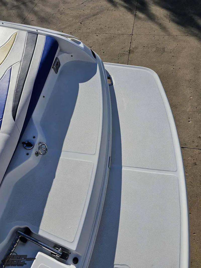 Slide: The Image of 2008 Baja 247 Islander boat deck with seating, white and blue upholstery. - 33