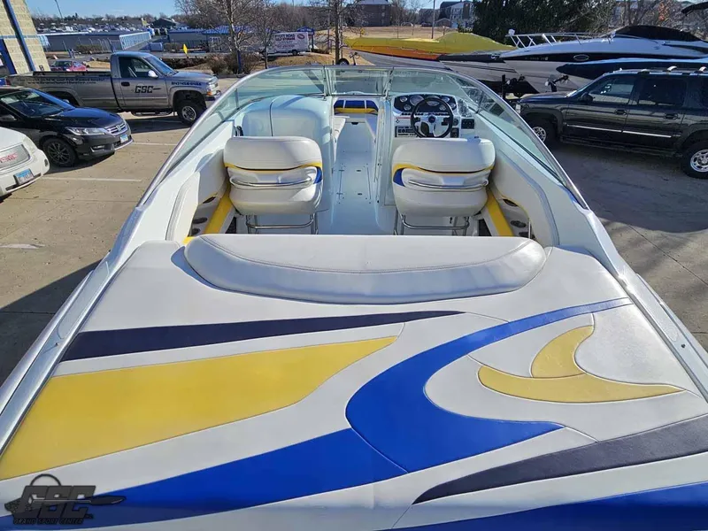 Slide: The Image of 2008 Baja 247 Islander boat with vibrant seating and sleek design in a parking area. - 35