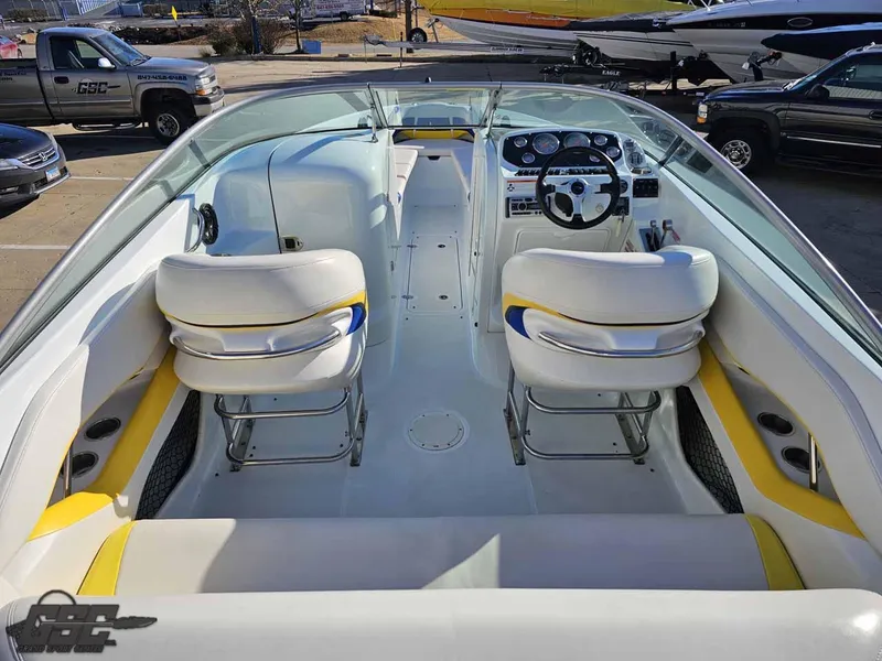 Slide: The Image of 2008 Baja 247 Islander boat interior with white and yellow seating, steering wheel, and dashboard. - 39