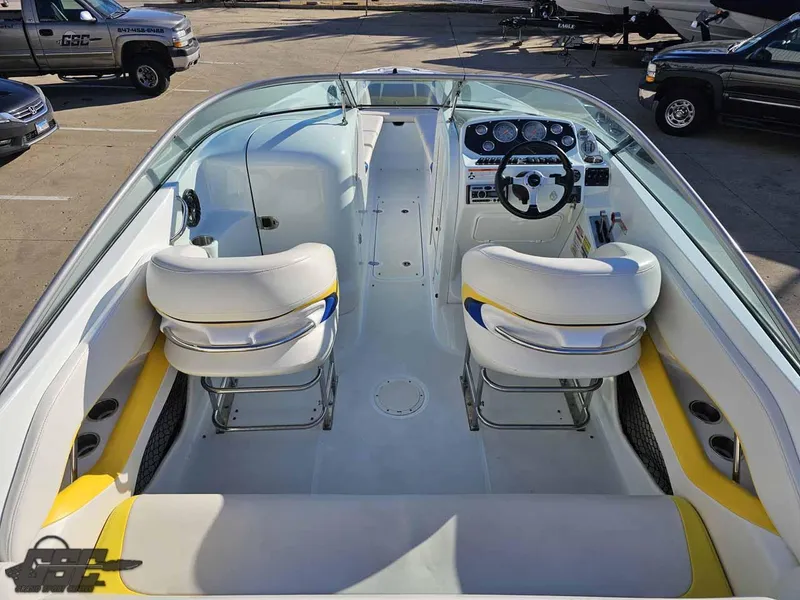 Slide: The Image of 2008 Baja 247 Islander boat interior with white and yellow seating, steering wheel, and dashboard. - 40