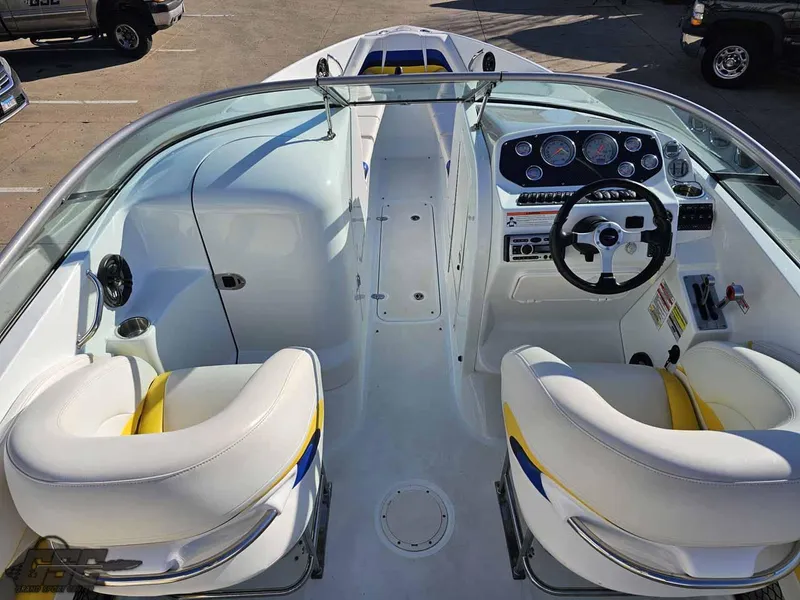 Slide: The Image of 2008 Baja 247 Islander boat interior with white and yellow seating, dashboard, and steering wheel. - 41
