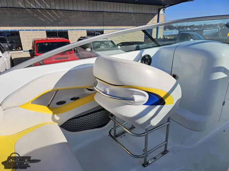 Slide: The Image of 2008 Baja 247 Islander boat interior with white and yellow seating, steering console visible. - 47