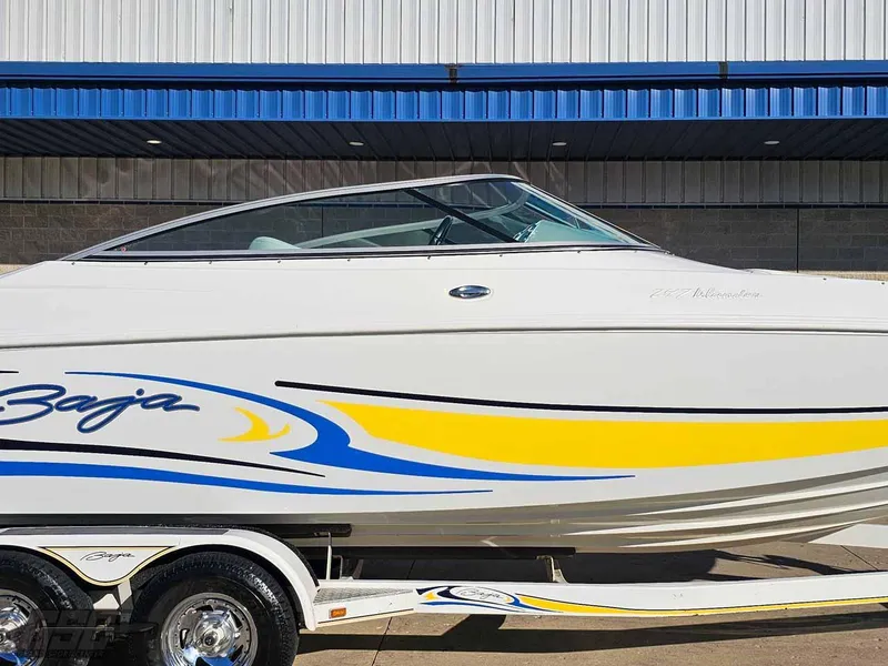 Slide: The Image of 2008 Baja 247 Islander boat with vibrant blue and yellow graphics on a trailer. - 5