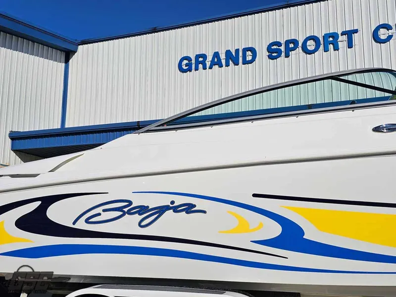 Slide: The Image of 2008 Baja 247 Islander boat at Grand Sport Center, featuring vibrant blue and yellow graphics. - 9