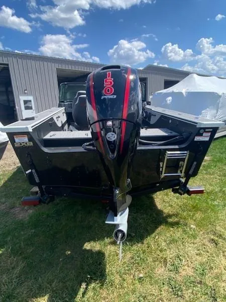Slide: The Image of 2023 Alumacraft Trophy 185 boat with a 150 HP outboard motor, parked outdoors. - 12