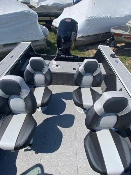 Slide: The Image of 2023 Alumacraft Trophy 185 boat interior with four seats and motor. - 5