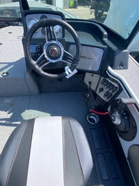 Slide: The Image of 2023 Alumacraft Trophy 185 boat cockpit with steering wheel and control panel. - 6