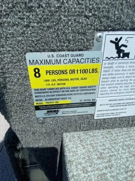 Slide: The Image of 2023 Alumacraft Trophy 185 capacity label, 8 persons or 1100 lbs, U.S. Coast Guard compliant. - 7