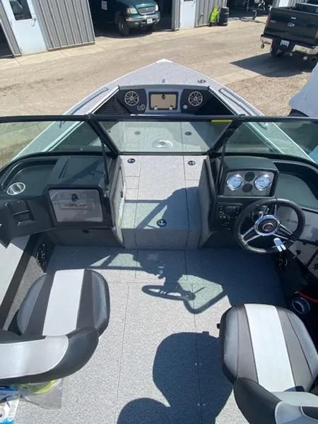 Slide: The Image of 2023 Alumacraft Trophy 185 boat interior with dual seats and dashboard controls. - 9