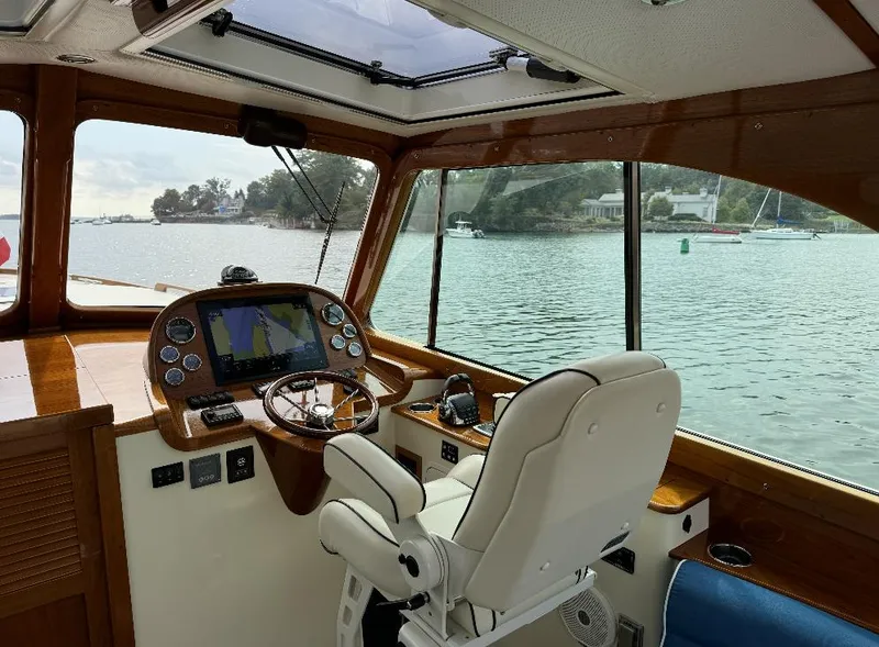 Slide: The Image of 2018 Hinckley Picnic Boat 37 MKIII helm with scenic water view. - 14