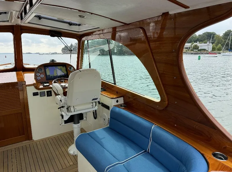 Slide: The Image of Interior of 2018 Hinckley Picnic Boat 37 MKIII with blue seating and wooden finish. - 15