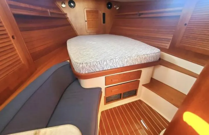 Slide: The Image of 2018 Hinckley Picnic Boat 37 MKIII cabin with cozy bed and wooden interior. - 20
