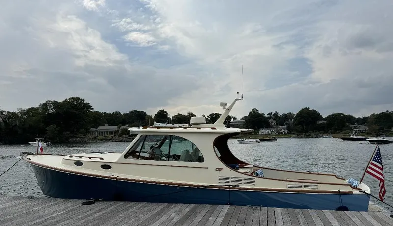 Slide: The Image of 2018 Hinckley Picnic Boat 37 MKIII docked by a serene waterfront. - 5