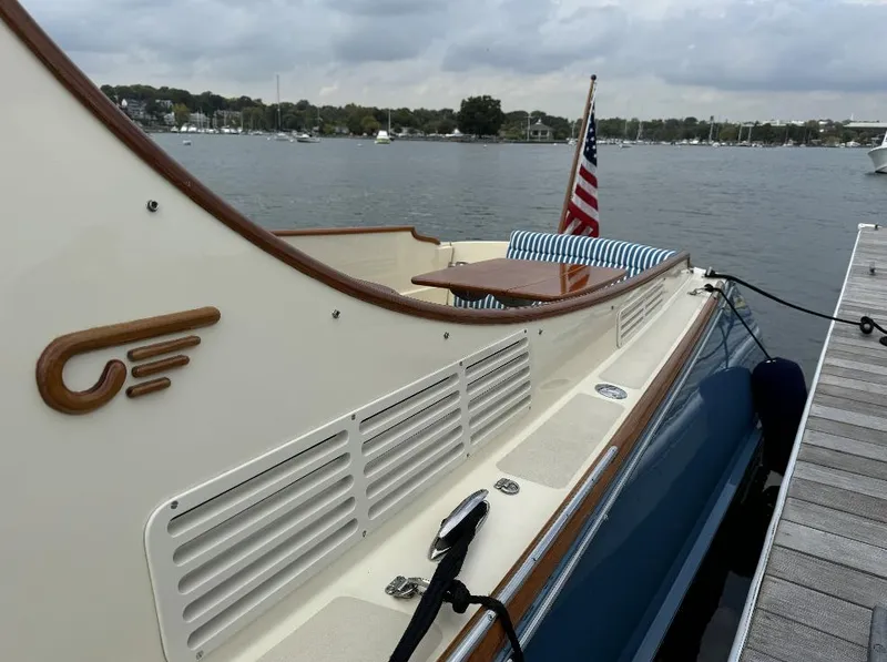 Slide: The Image of 2018 Hinckley Picnic Boat 37 MKIII docked, featuring elegant design and American flag. - 7