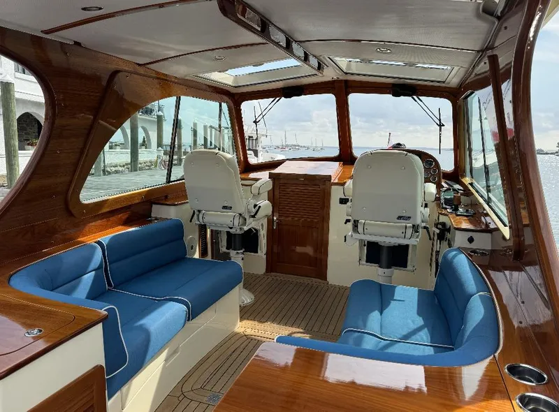 Slide: The Image of Interior of 2018 Hinckley Picnic Boat 37 MKIII with blue seating and wooden finishes. - 13