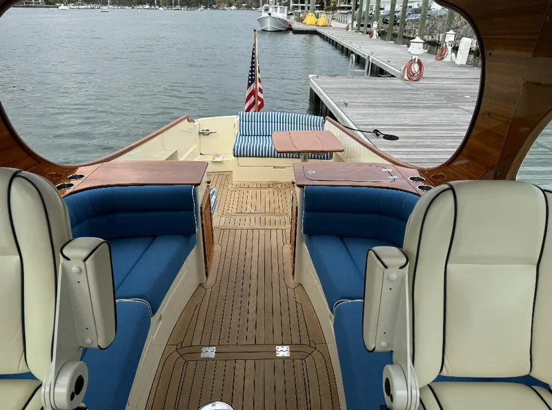 Slide: The Image of 2018 Hinckley Picnic Boat 37 MKIII with elegant seating and wooden deck by the dock. - 17
