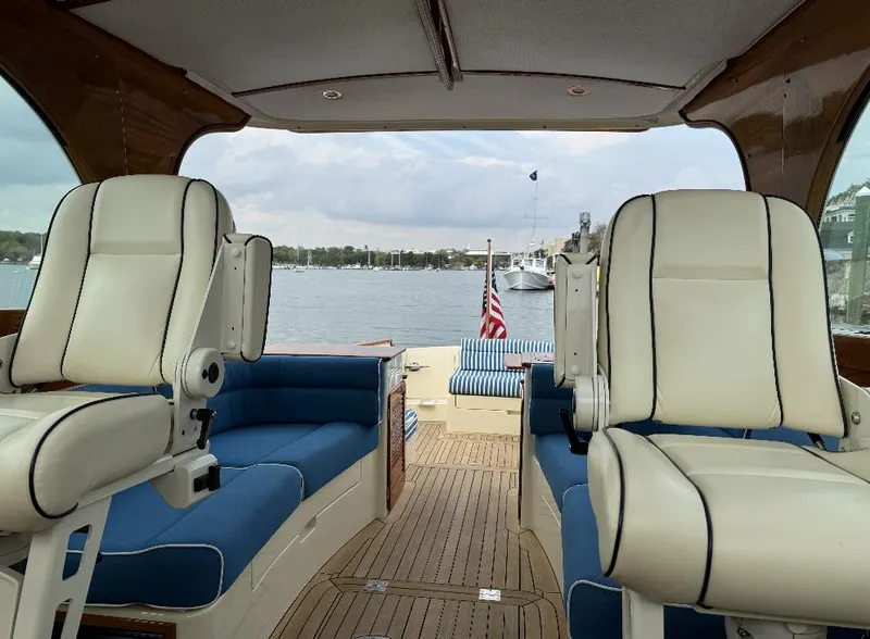 Slide: The Image of 2018 Hinckley Picnic Boat 37 MKIII interior with plush seating and scenic water view. - 18