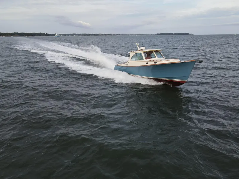 Slide: The Image of 2018 Hinckley Picnic Boat 37 MKIII cruising on open water. - 3