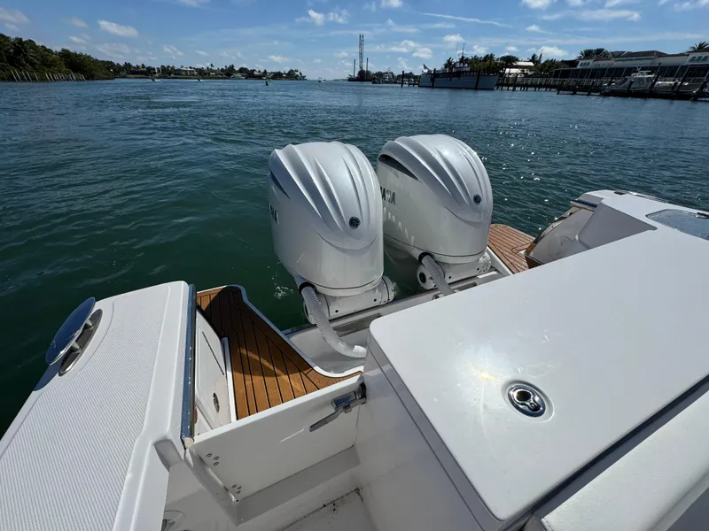 Slide: The Image of 2024 Southport 30 FE boat with dual outboard engines on calm water. - 17
