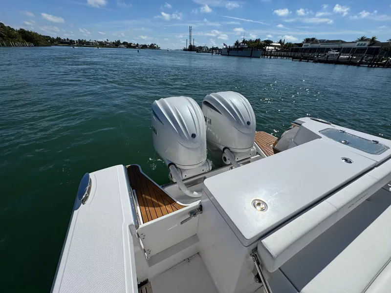 Slide: The Image of 2024 Southport 30 FE boat with dual outboard motors on calm water. - 18