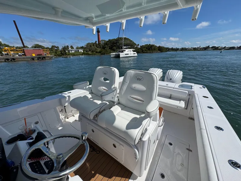 Slide: The Image of 2024 Southport 30 FE boat interior with helm seats on a sunny day. - 19