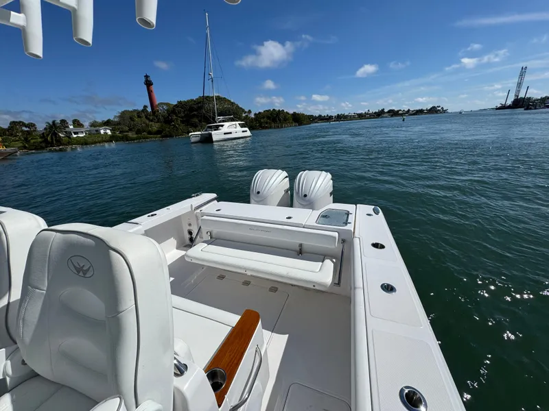 Slide: The Image of 2024 Southport 30 FE boat on calm waters with scenic lighthouse view. - 20