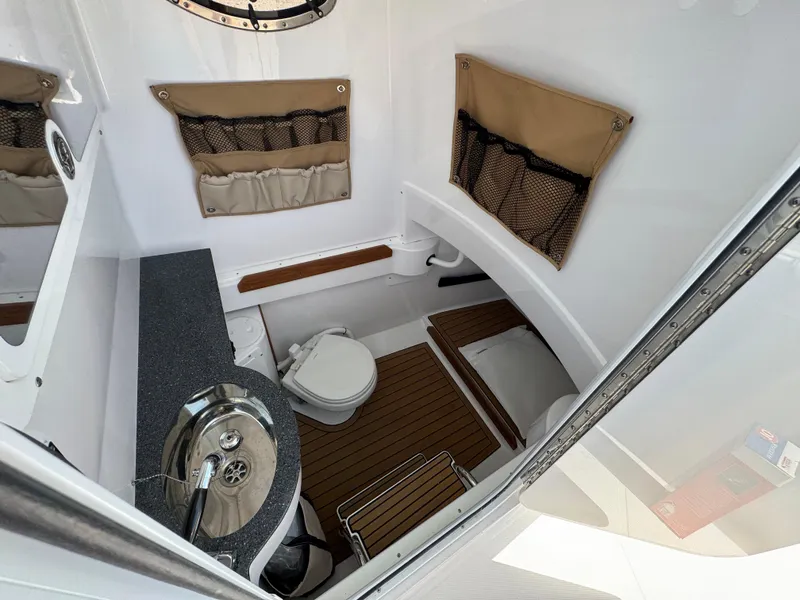 Slide: The Image of 2024 Southport 30 FE boat interior with compact bathroom and sink. - 22