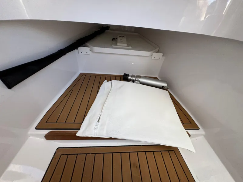Slide: The Image of 2024 Southport 30 FE interior with wooden flooring and storage compartment. - 24