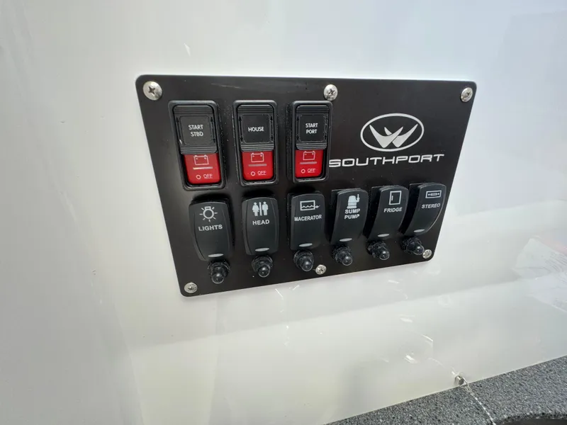 Slide: The Image of Control panel of 2024 Southport 30 FE boat with labeled switches and logo. - 25