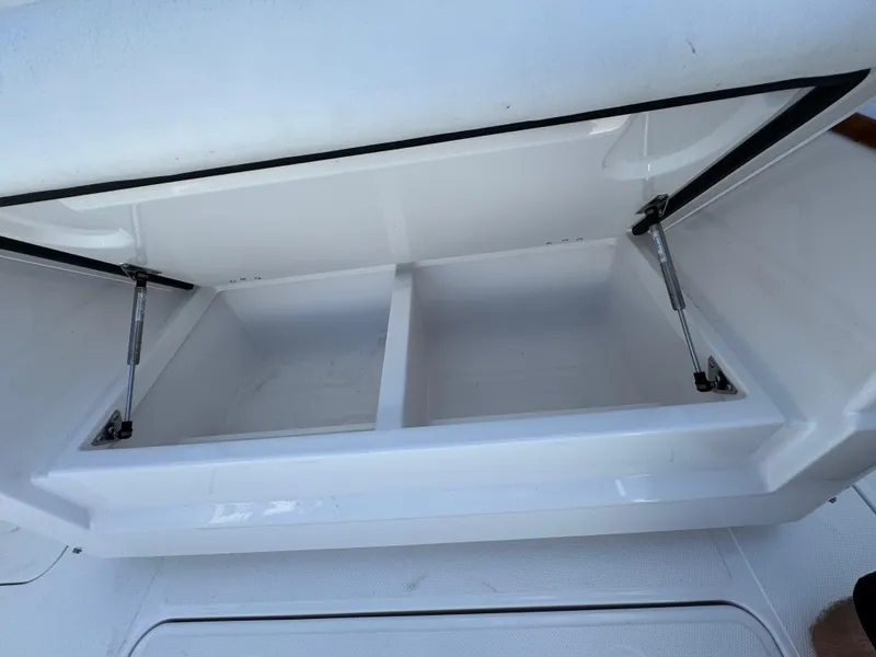 Slide: The Image of 2024 Southport 30 FE storage compartment with dual sections and hydraulic supports. - 26