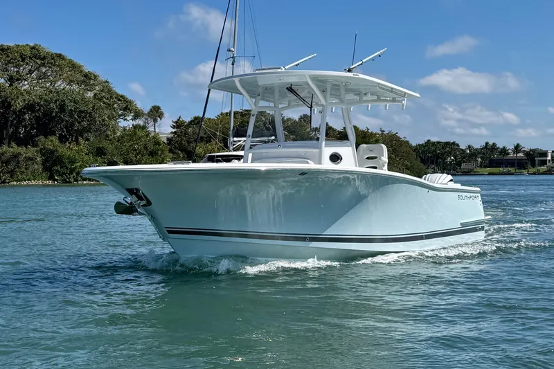 Slide: The Image of 2024 Southport 30 FE boat cruising on a sunny day in calm waters. - 29