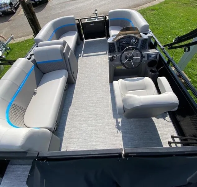 Slide: The Image of 2024 Qwest E814 CTR Cruise L pontoon boat interior with gray seating and steering console. - 2