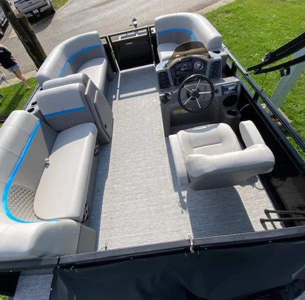 Slide: The Image of 2024 Qwest E814 CTR Cruise L pontoon boat interior with gray seating and steering console. - 5