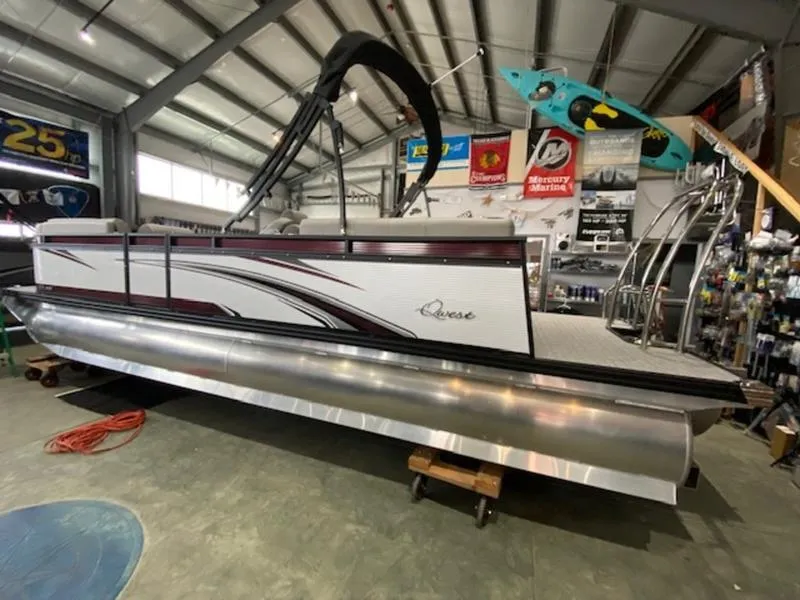 Slide: The Image of 2023 Qwest 824 E-Class RLS Triple Tube LTZ pontoon boat in showroom. - 2